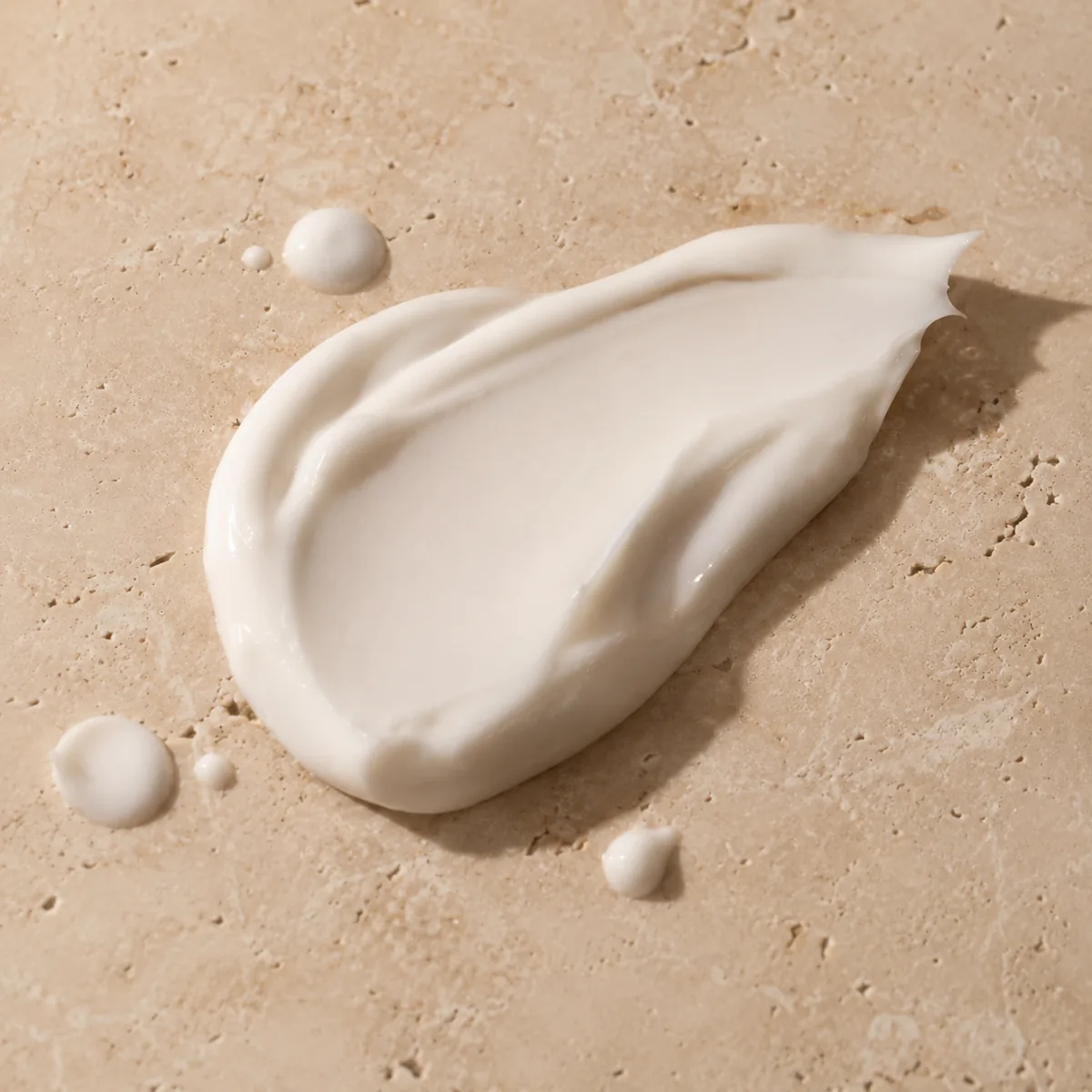 Rich brightening cream texture on natural stone